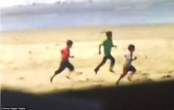 A blurry image of three children running